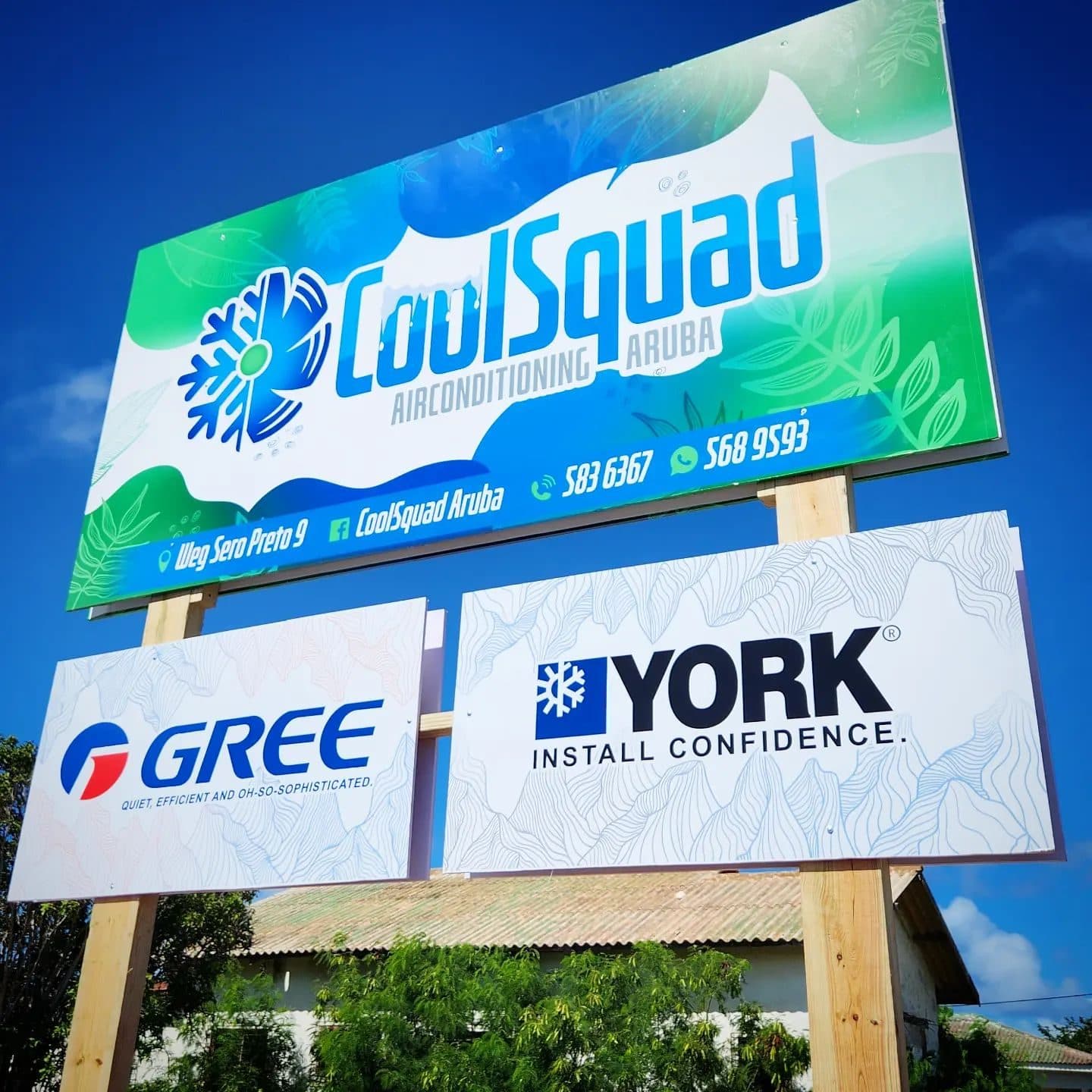 CoolSquad airconditioning billboard against a blue sky